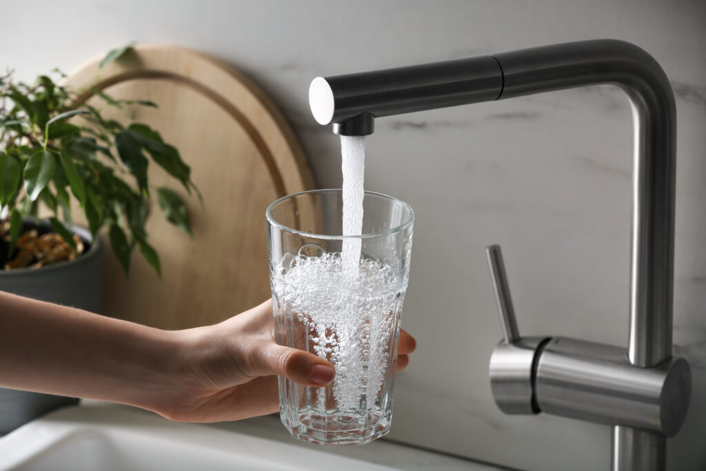 Filling a glass of water from kitchen tap